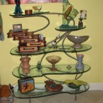 Patina bronze shelves. Carved and painted glass by Alisha Volotzky.