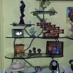 Patina bronze shelves. Carved and painted glass by Alisha Volotzky.