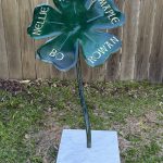 Outdoor botanical metal sculpture with blue and green elements by Rhonda Kap