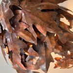 Close-up detail of textured copper wall sculpture by Rhonda Kap