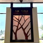 Custom metal tree artwork installed in an architectural doorway by Rhonda Kap